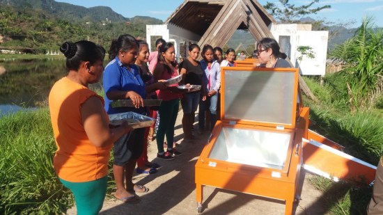 Magda Catorceno (Photographed behind the oven providing training) President of the Inti Illimani Association